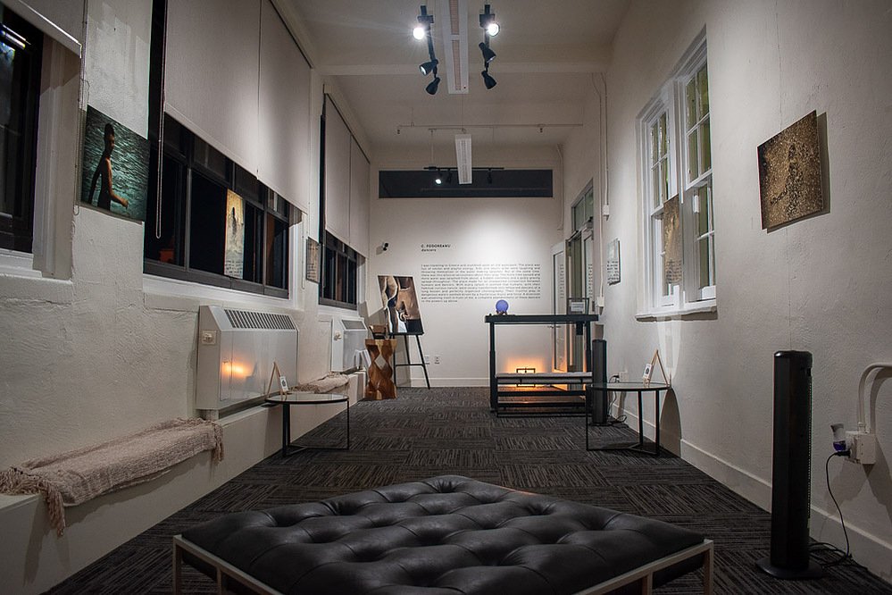 dancers, installation view at Cornel/Henry Art, San Diego, 2019 — gallery hallway with framed photographs hung salon-style on either wall