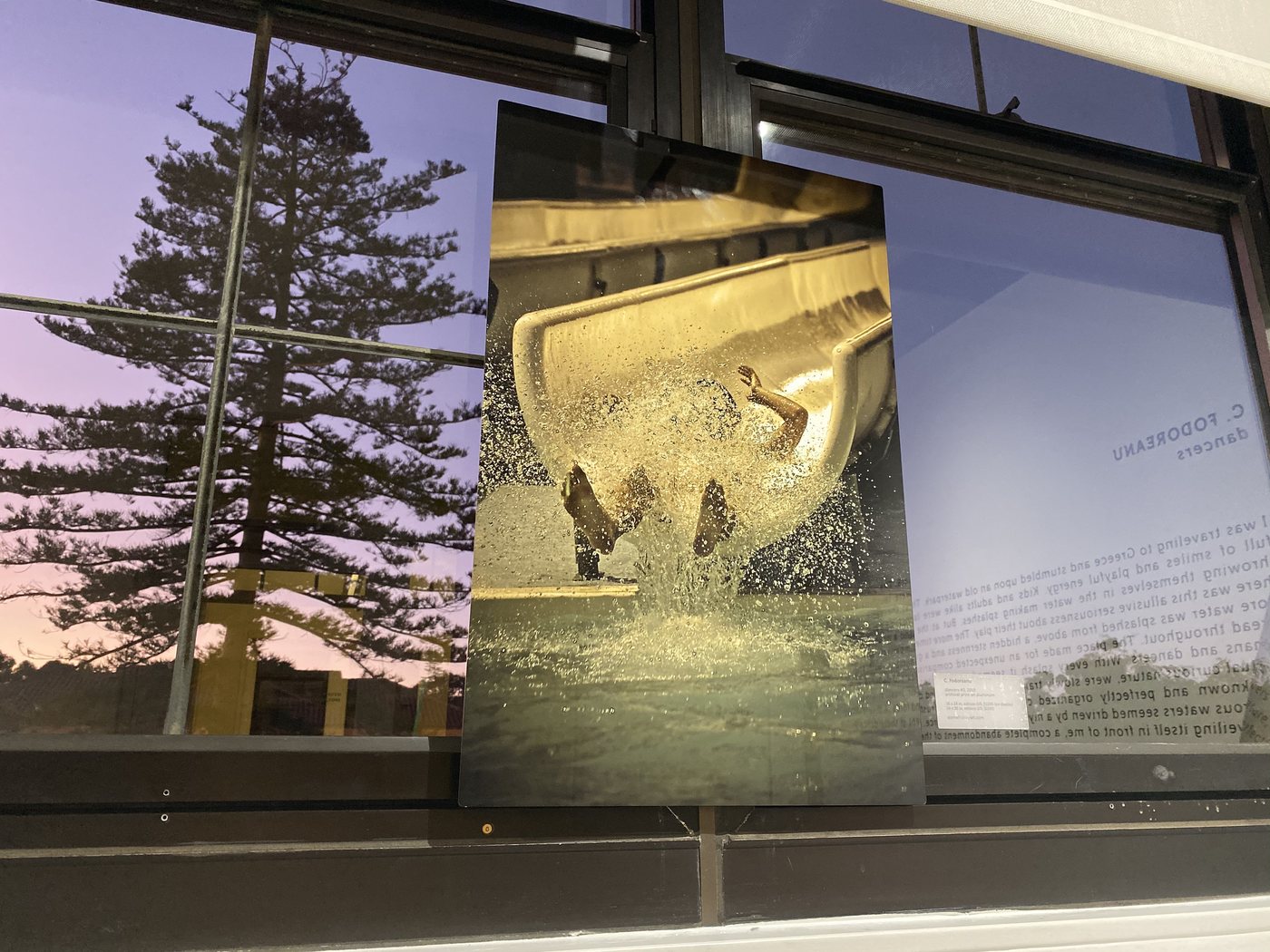 dancers, installation view at Cornel/Henry Art, San Diego, 2019 — a framed photograph of a figure in a sweep of gold water, against the gallery windows