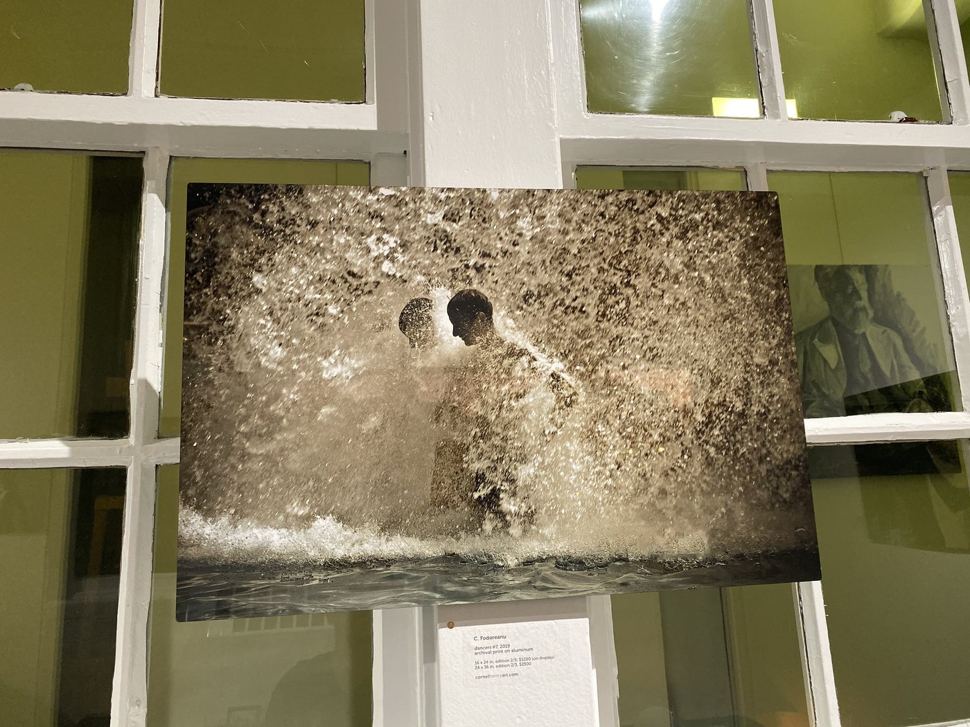 dancers, installation view at Cornel/Henry Art, San Diego, 2019 — a framed photograph of figures in white spray, against the gallery windows