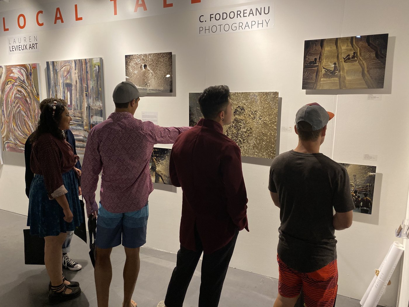 dancers, installation view at Art San Diego 2019 — visitors viewing the framed photographs in the C Fodoreanu Photography booth of the [LOCAL TALENT] program, beside Lauren Levieux Art