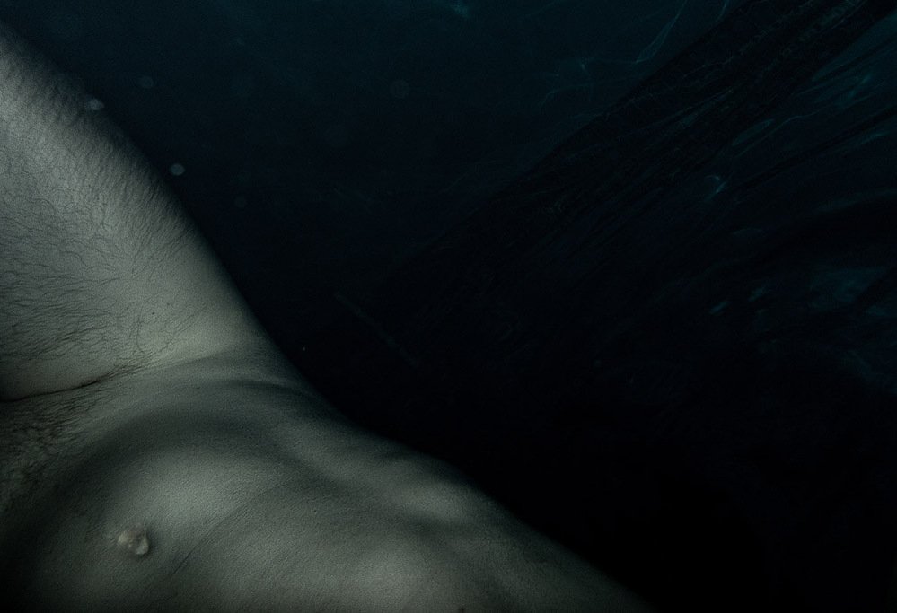 night swim #2, nude figure underwater in deep blue darkness, 2020