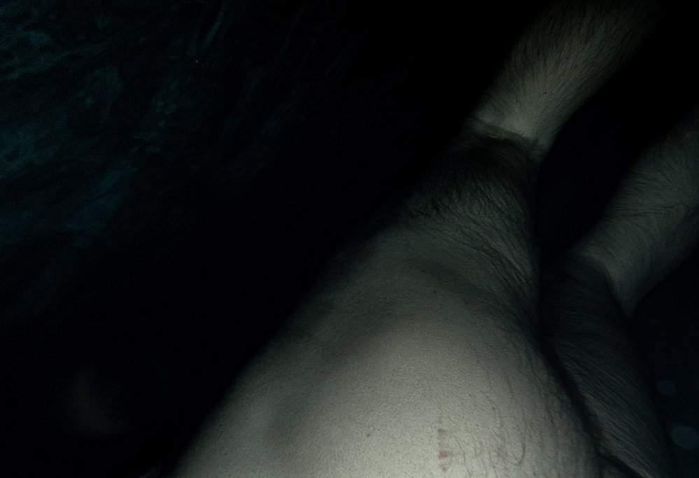 night swim #3, dimly lit body submerged in dark water, 2020